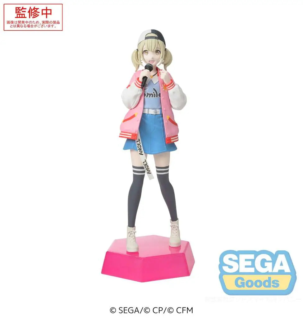 The Sega Desktop x Decorate: Hatsune Miku: Colorful Stage! Azusawa Kohane figure by SEGA shows Kohane in a pink varsity jacket, blue skirt, white boots, backward cap, holding a microphone on a pink base. SEGA logo is at the bottom right.