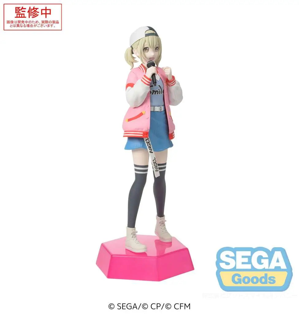The Sega Desktop x Decorate: Hatsune Miku: Colorful Stage! Azusawa Kohane by SEGA features Kohane in a pink varsity jacket, blue skirt, striped socks, sneakers, and cap, holding a mic on a pink hexagonal base with the SEGA logo.