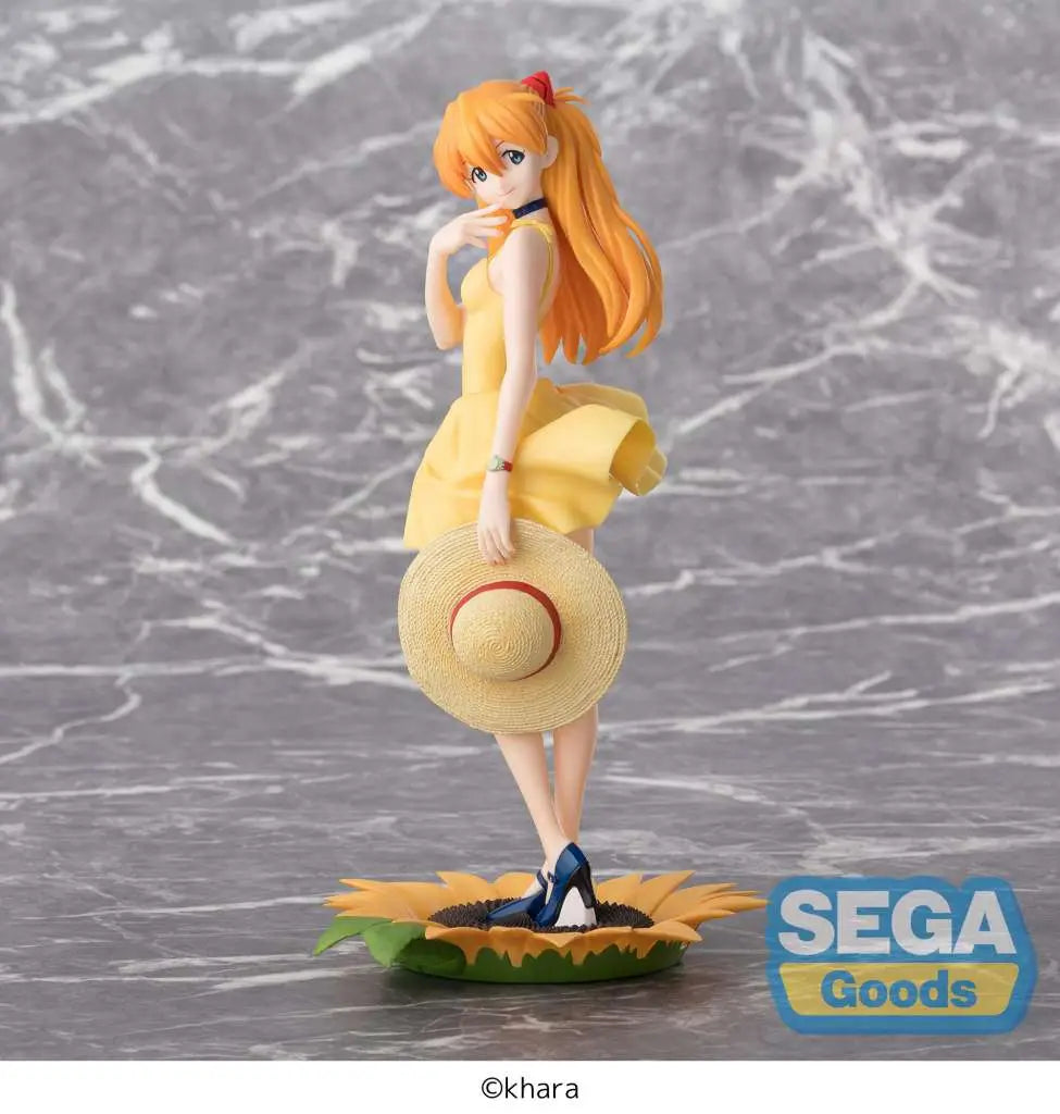 The SEGA Rebuild of Evangelion Luminasta: Asuka Langley Shikinami (Summer Dress Ver. 2) PVC Statue (24 cm) shows Asuka in a yellow dress and straw hat, posed on a sunflower base, with long orange hair; gray marbled background and SEGA Goods logo.