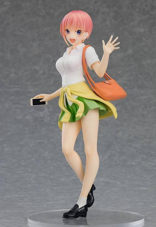 The Good Smile Company The Quintessential Quintuplets the Movie: Ichika Nakano – Pop Up Parade (Ver. 1.5) figure features Ichika in a white blouse, green-yellow skirt, black shoes, orange bag, with short pink hair, smiling, waving, and holding a phone.