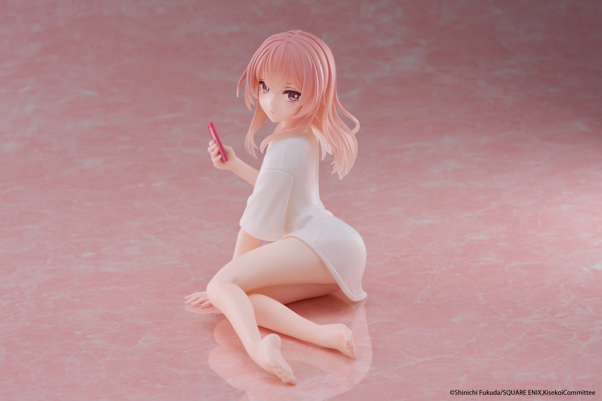 The Taito Desktop Cute Sajuna Inui T-shirt Ver. PVC Figure (13 cm) by Taito features a pink-haired anime character kneeling on a glossy pink surface, looking over her shoulder in a loose white shirt and holding a pink object.