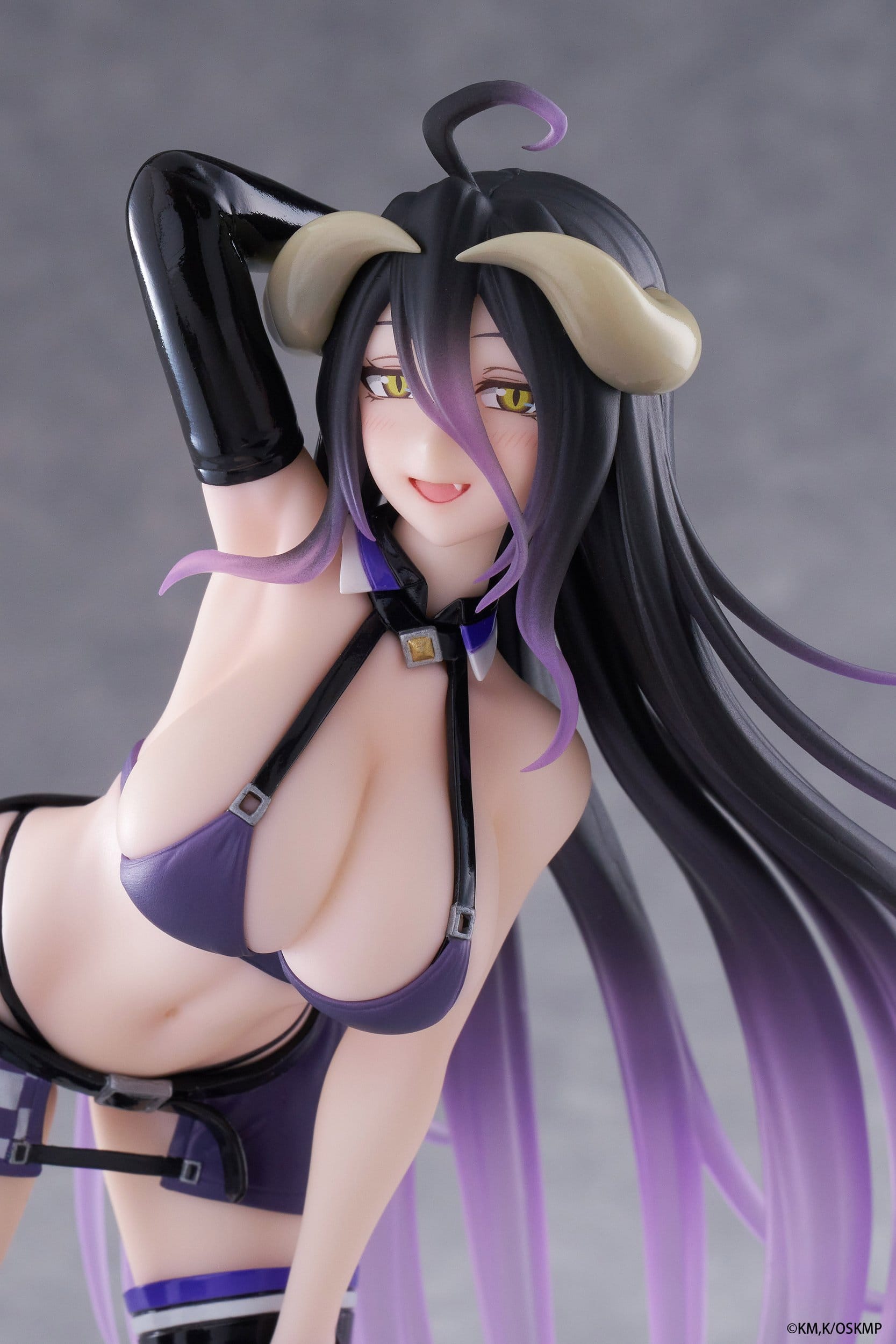 A close-up of the Taito Coreful Albedo Grid Girl Version PVC Statue (18 cm) by Taito highlights her long black and purple hair, horn-like accessories, yellow eyes, and a striking outfit as she poses with one hand behind her head.
